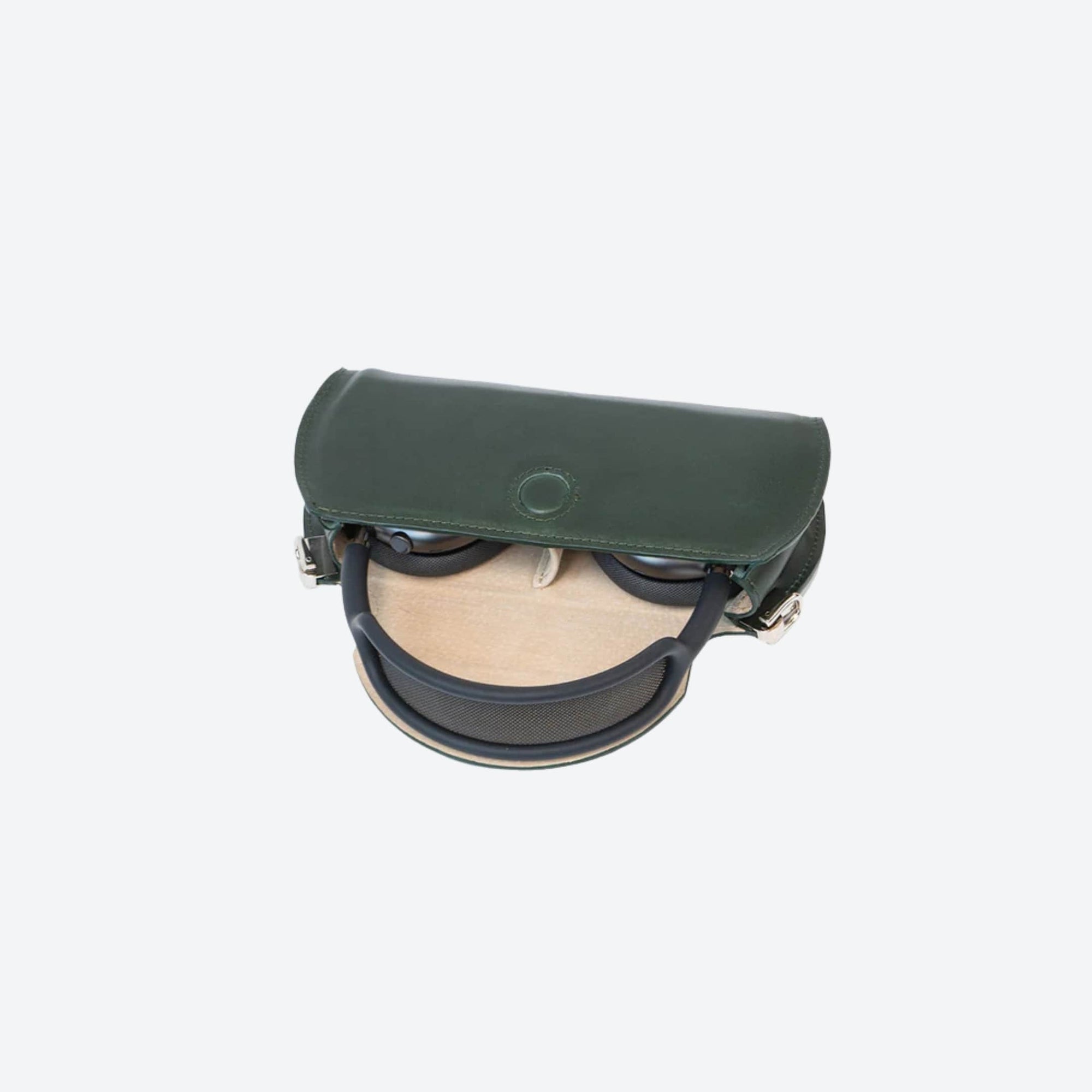 Green leather case with round object inside on a white background