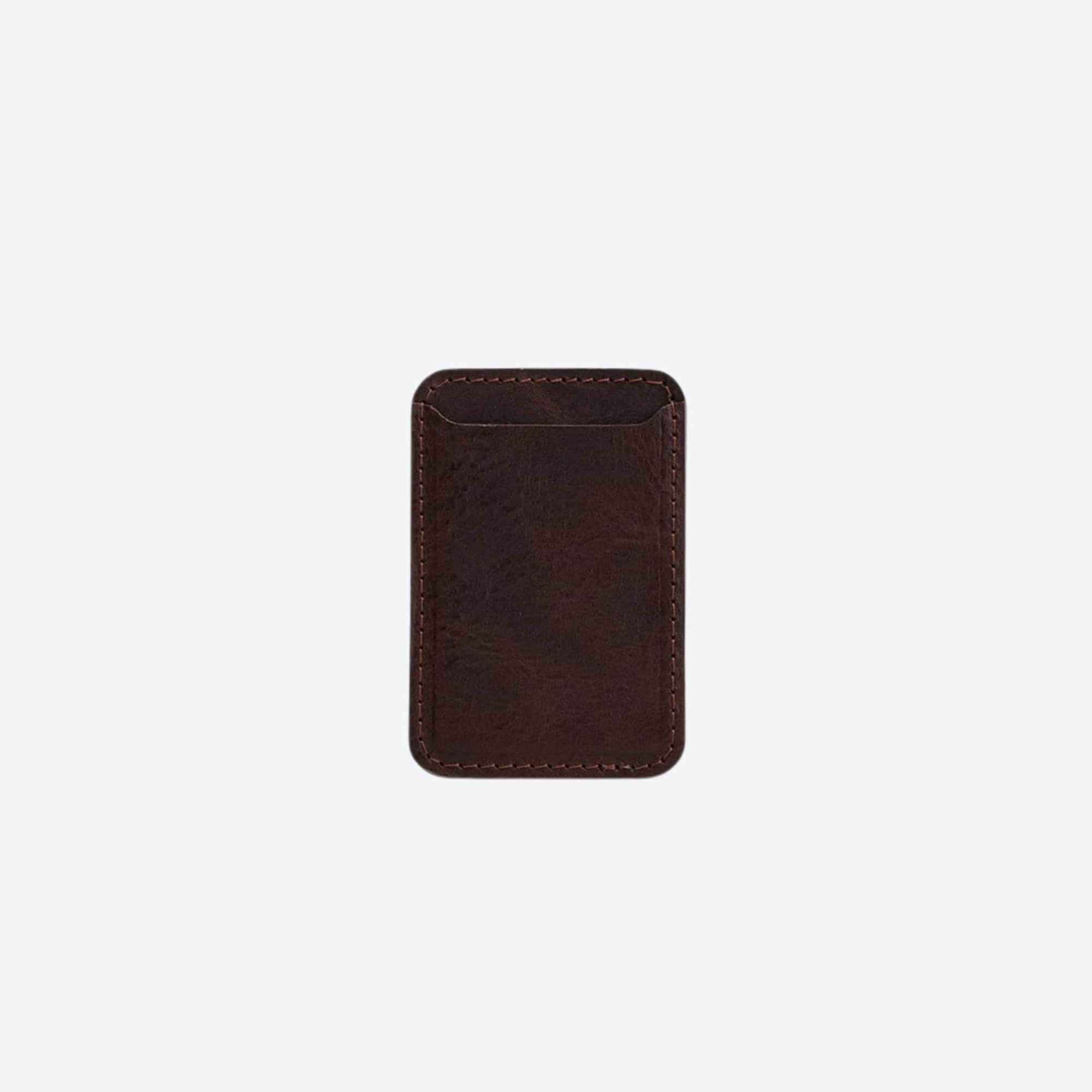 Brown leather cardholder on a light beige background